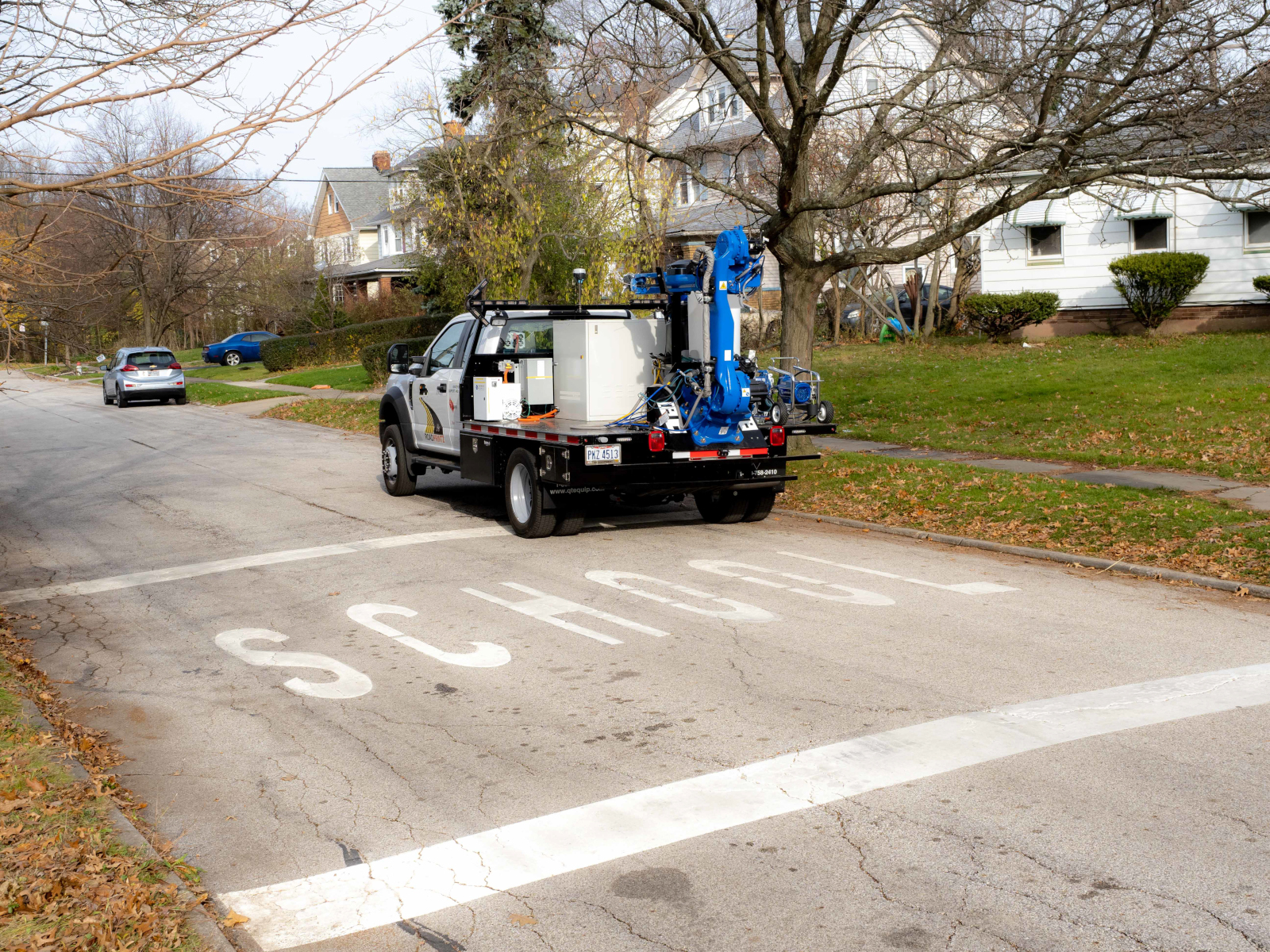 Pavement marking robt truck on residential street; school zone marking